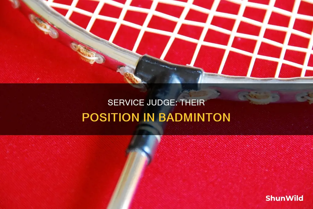 where does the service judge stand in badminton