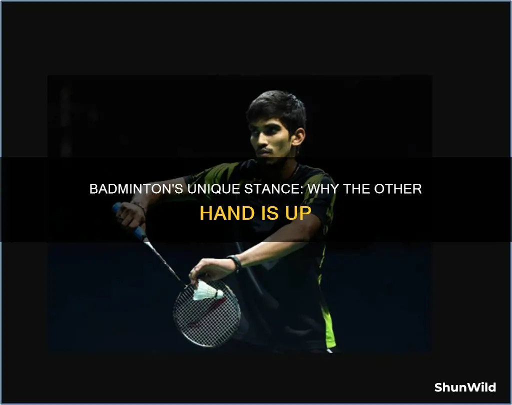 why do badminton players have their other hand uo